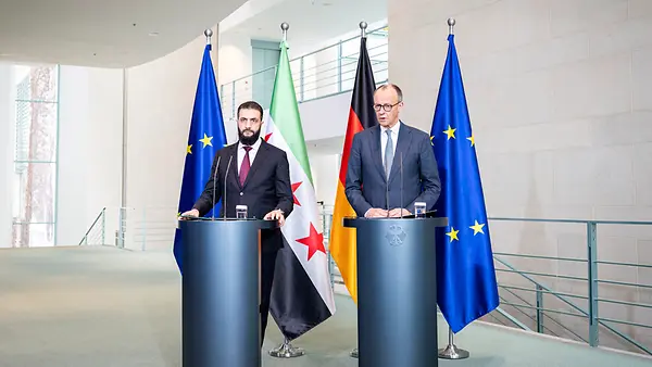 Bundeskanzler Friedrich Merz und der syrische Präsident Ahmed al-Scharaa am Rednerpult im Kanzleramt.