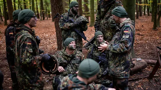 Reservisten im Wald bei einer Besprechung