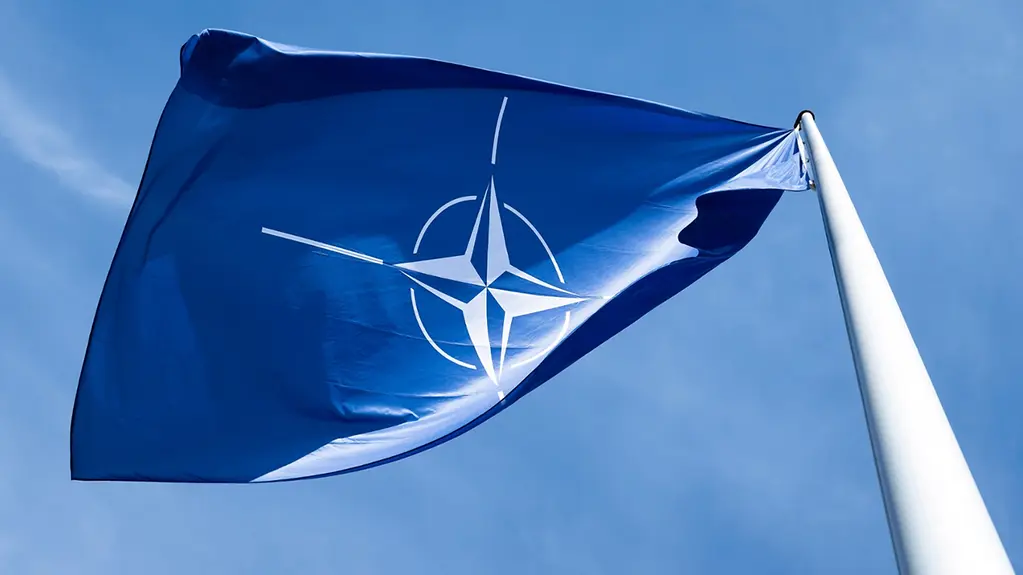 The NATO flag flies in front of the Federal Chancellery.