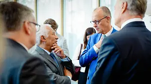 Chancellor Friedrich Merz in conversation at the EU Arctic Summit.