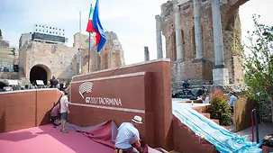 Workers lay a carpet in preparation for the G7 summit.