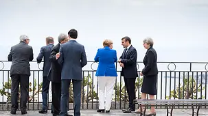 Chancellor Angela Merkel talks to French President Emmanuel Macron at the G7 summit.