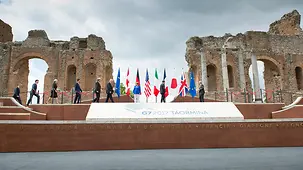 G7 summit participants gather for a group photo.