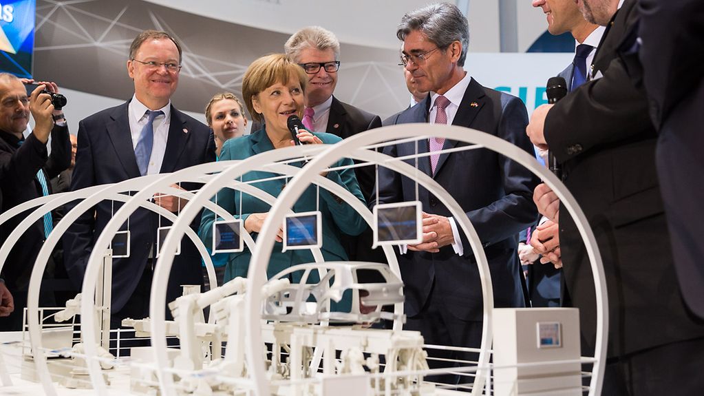Chancellor Angela Merkel at a stand during her tour of the Hannover Messe