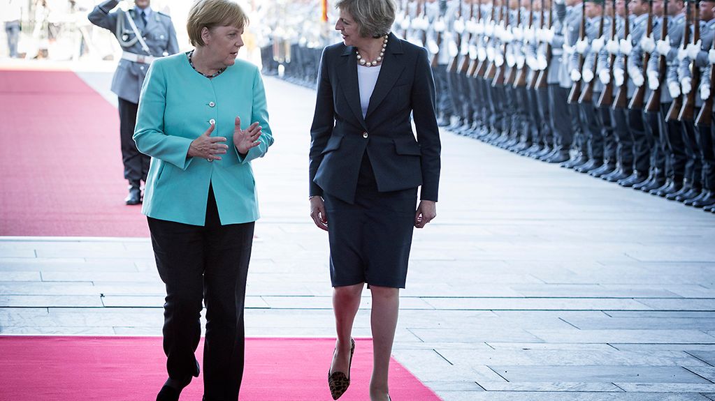 Chancellor Angela Merkel welcomes the new British Prime Minister Theresa May with military honours at the Federal Chancellery