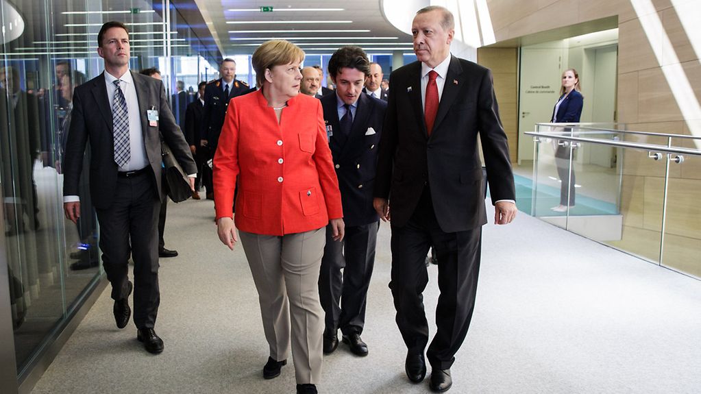 Chancellor Angela Merkel in conversation with Turkish President Recep Tayyip Erdogan at the NATO summit in Brussels