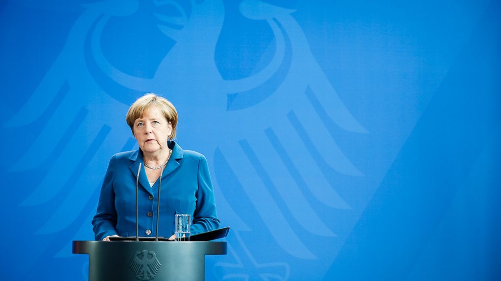 Chancellor Angela Merkel reads a statement to the press.