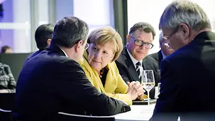 Chancellor Angela Merkel in discussion with ECB President Mario Draghi.