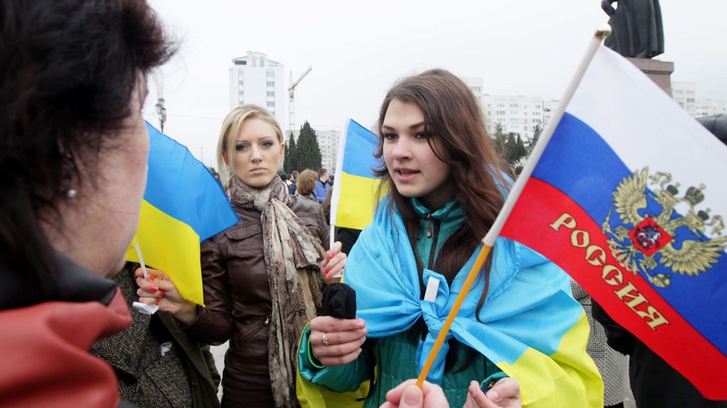 Young women with Russian and Ukrainian flags