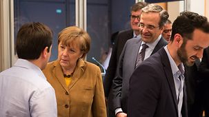 Chancellor Angela Merkel talks to representatives of Greek start-ups.