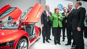 Angela Merkel and Vladimir Putin beside the Volkswagen VW XL1