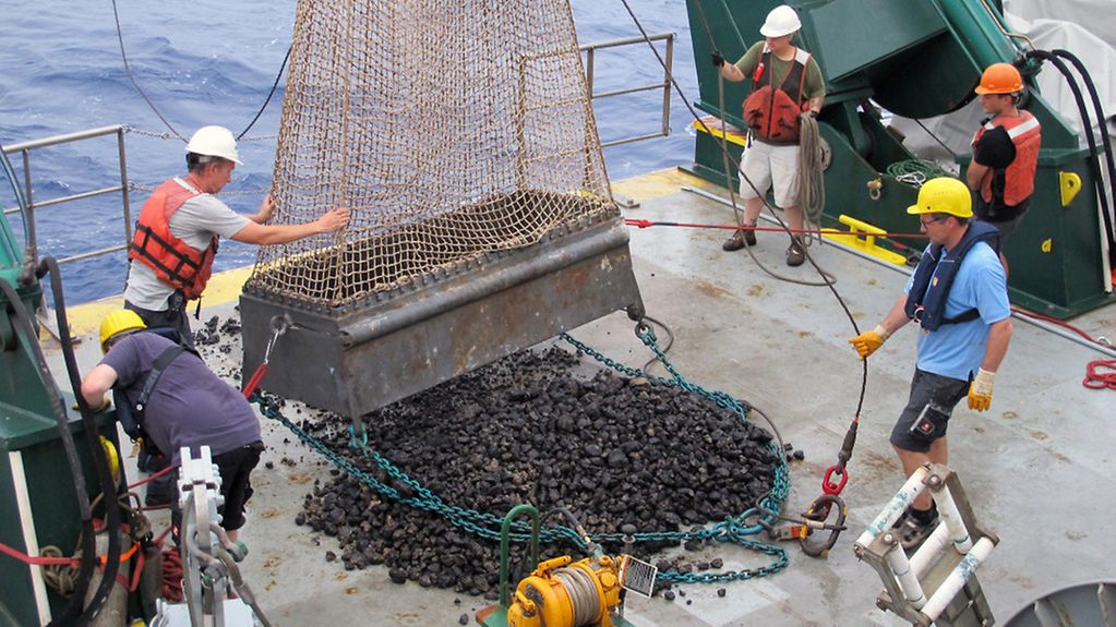 Einholen Dregde: Wissenschaftler der BGR holen eine Kettensack-Dredge an Bord. Das Gerät wird an einem Drahtseil unter Wasser hinter dem Forschungsschiff hergezogen und sammelt auf diese Weise die Manganknollen vom Meeresboden auf.