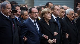 Chancellor Angela Merkel marches with many other heads of state and government.