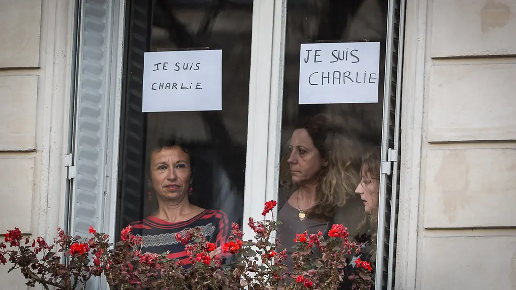 People stand at a window.