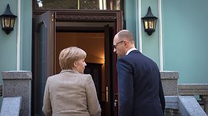 Angela Merkel and Arseniy Yatsenyuk deep in discussion