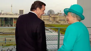 Chancellor Gerhard Schröder talks to the Queen on one of the balconies of the Federal Chancellery.