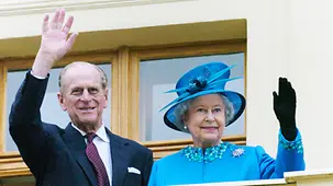 Queen Elizabeth the Second and Prince Philip, the Duke of Edinburgh wave to the crowd during a visit to the Bornstedt Crown Estate in 2004.