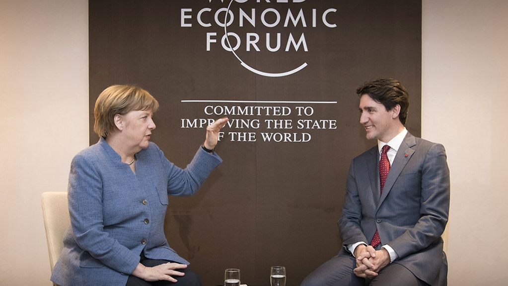 Chancellor Angela Merkel and Canadian Prime Minister Justin Trudeau deep in discussion at the World Economic Forum.
