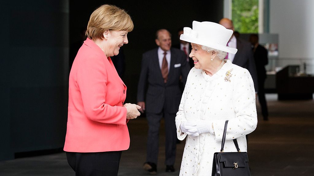 German Chancellor Angela Merkel talks with Queen Elizabeth II