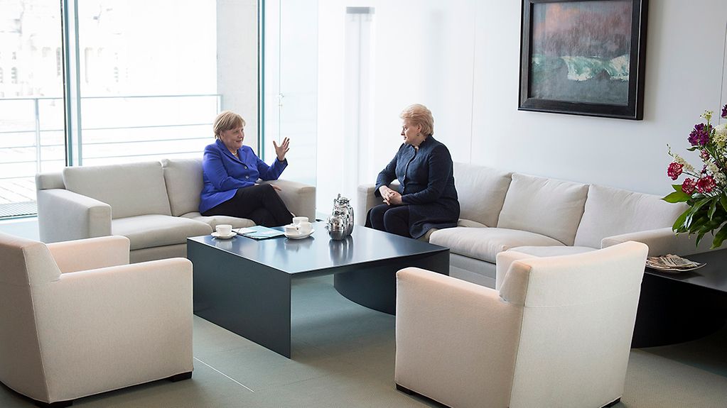 Chancellor Angela Merkel deep in conversation with Lithuanian President Dalia Grybauskaite
