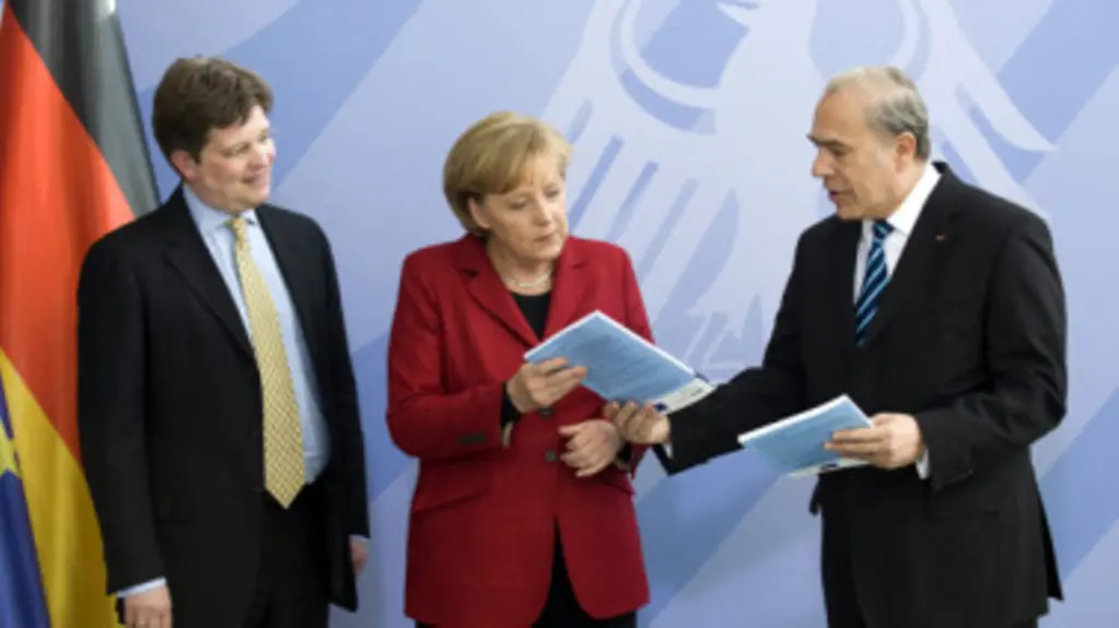 Staatsminister von Klaeden und die Bundeskanzlerin bei der Übergabe des OECD-Berichts