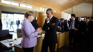 Chancellor Angela Merkel in conversation with President Barack Obama