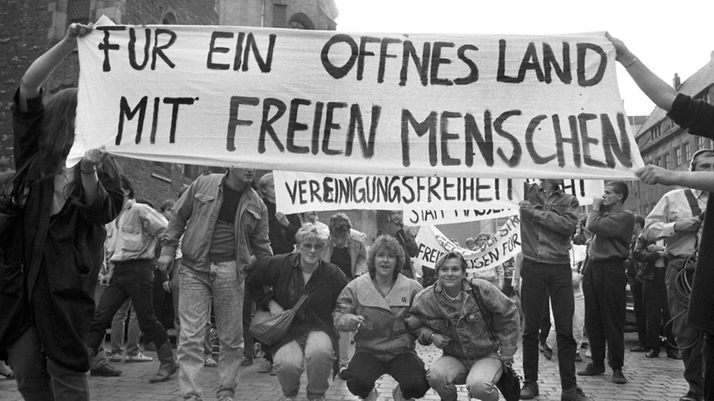 Bei einer Montagsdemonstration in Leipzig wird ein Transparent mit der Aufschrift 'Für ein offenes Land mit freien Menschen' getragen.