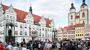 Besucher stehen am 20.09.2016 während einer Veranstaltung auf dem Marktplatz in Lutherstadt Wittenberg (Sachsen-Anhalt). Im Jahr 2017 feiert die Stadt das Reformationsjubiläum. Der Überlieferung nach hatte der Theologe Martin Luther (1483-1546) am 31. …