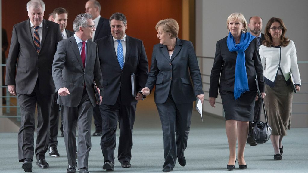 Bundeskanzlerin Angela Merkel neben Innenminister de Maiziere und Vizekanzler Gabriel auf dem Weg zu PK.