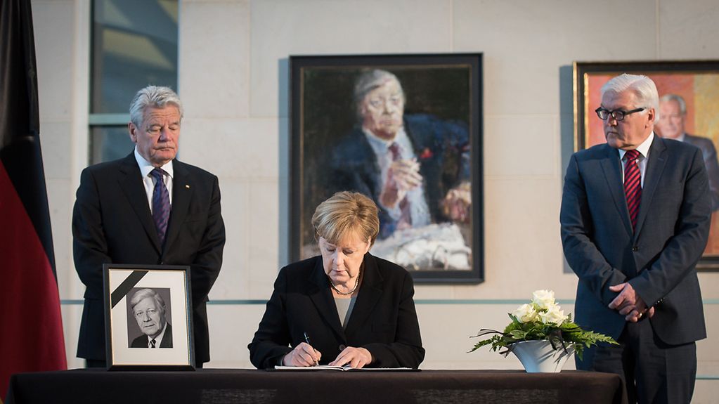 Chancellor Angela Merkel signs the book of condolence for the late Helmut Schmidt in the presence of Federal President Joachim Gauck and Federal Foreign Minister Frank-Walter Steinmeie.