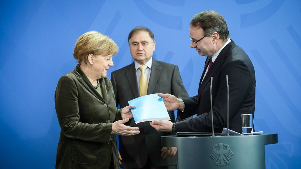 Bundeskanzlerin Angela Merkel nimmt das Jahresgutachten 2014 der Expertenkommission Forschung und Innovation (EFI) der Bundesregierung vom Kommission-Vorsitzenden Dietmar Harhoff und Alexander Gerybadze entgegen.
