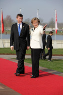 Chancellor Angela Merkel welcomes the Estonian Prime Minister Andrus Ansip to the NATO summit at the footbridge, the Passerelle des deux Rives, in Kehl