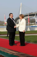 Chancellor Angela Merkel welcomes the Icelandic Foreign Minister to the NATO summit at the Passerelle des deux Rives in Kehl
